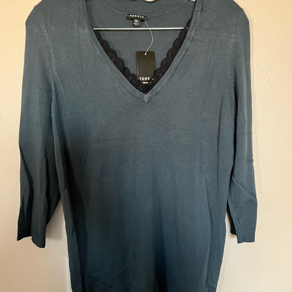 Blue blouse/sweater with black lace. Material stretches, size 00.